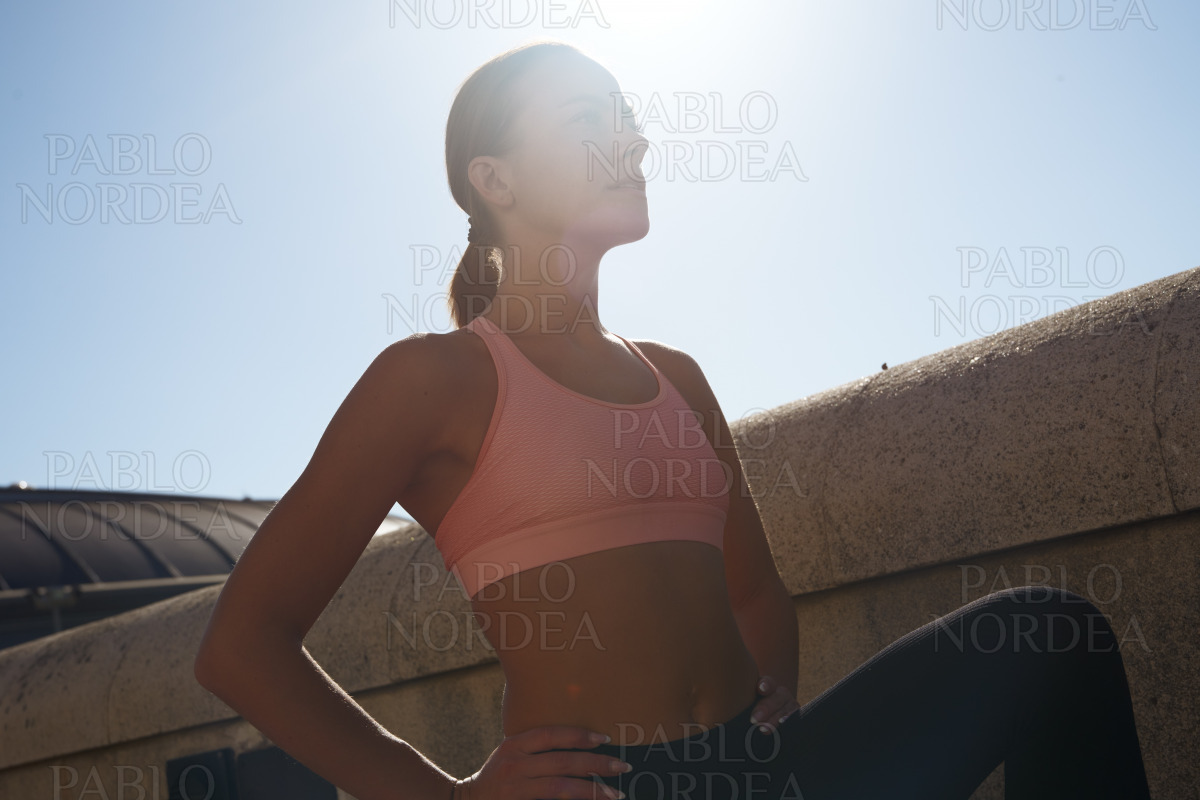 Beautiful blond woman exercising in park stock photo