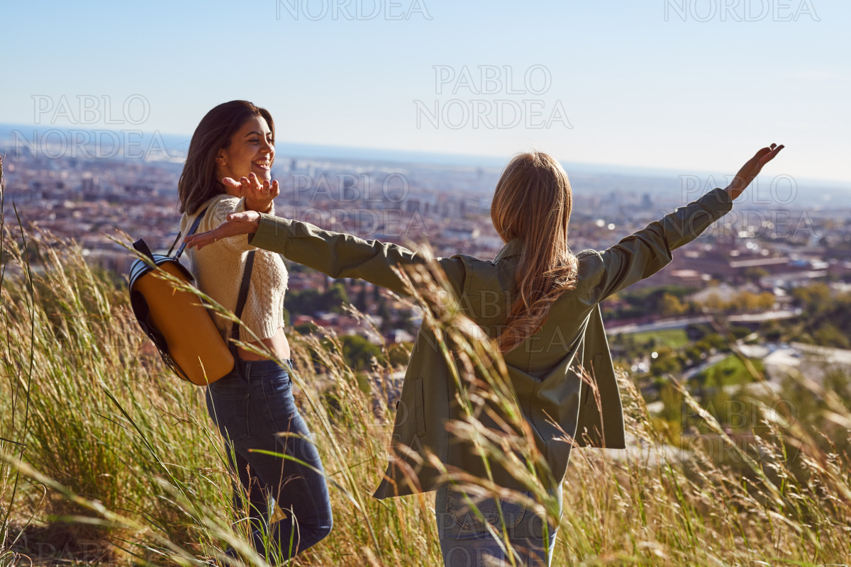 Cheerful female friends celebrating during a hike stock photo