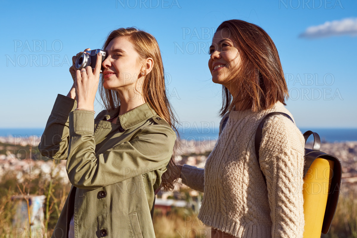 Happy female friends standing and smiling stock photo