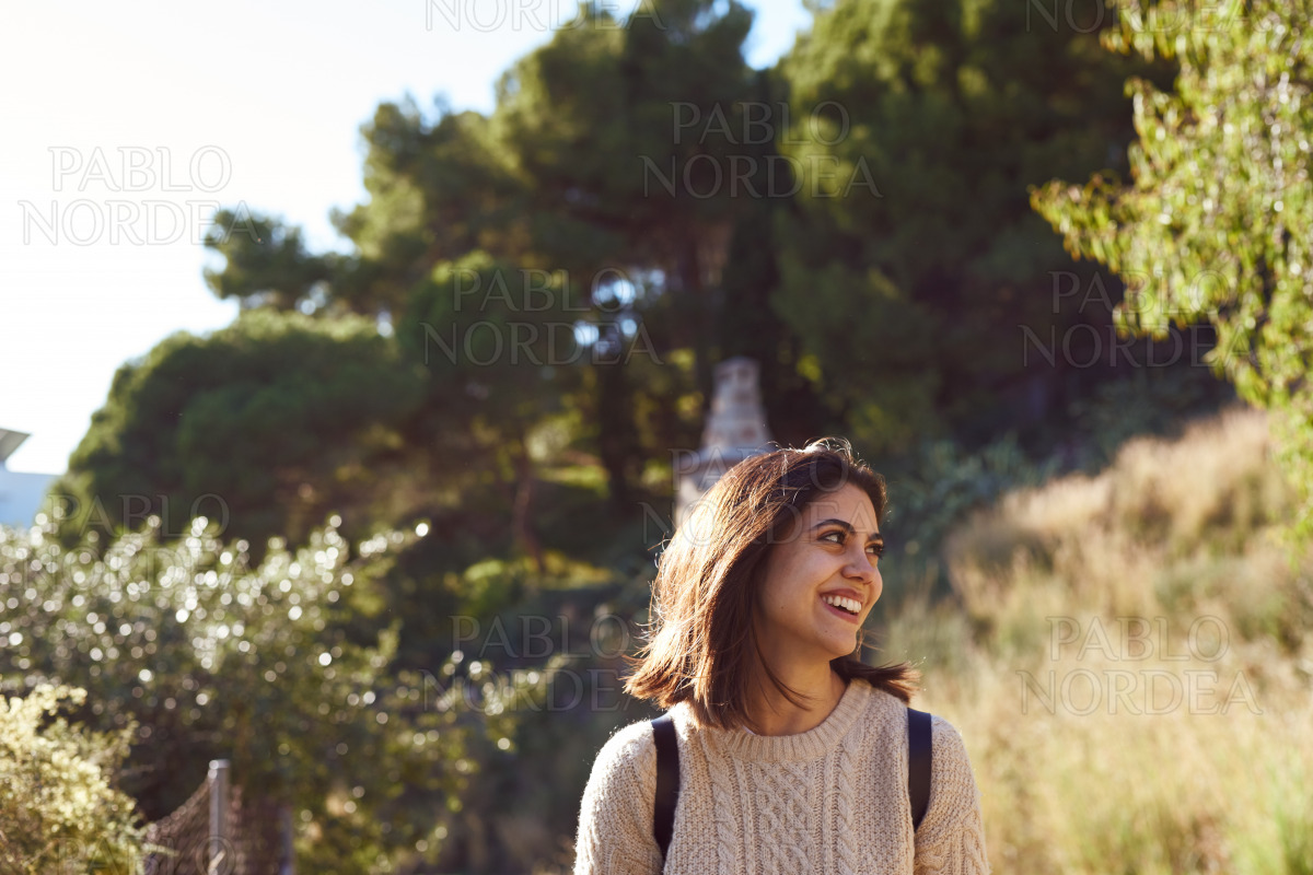 Happy young woman looking away cheerfully stock photo