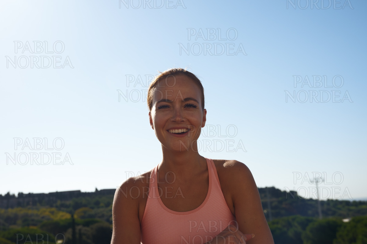 Portrait of smiling woman in pink sports bra stock photo