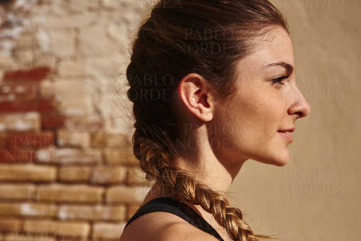 Pretty young woman is looking into the distance stock photo