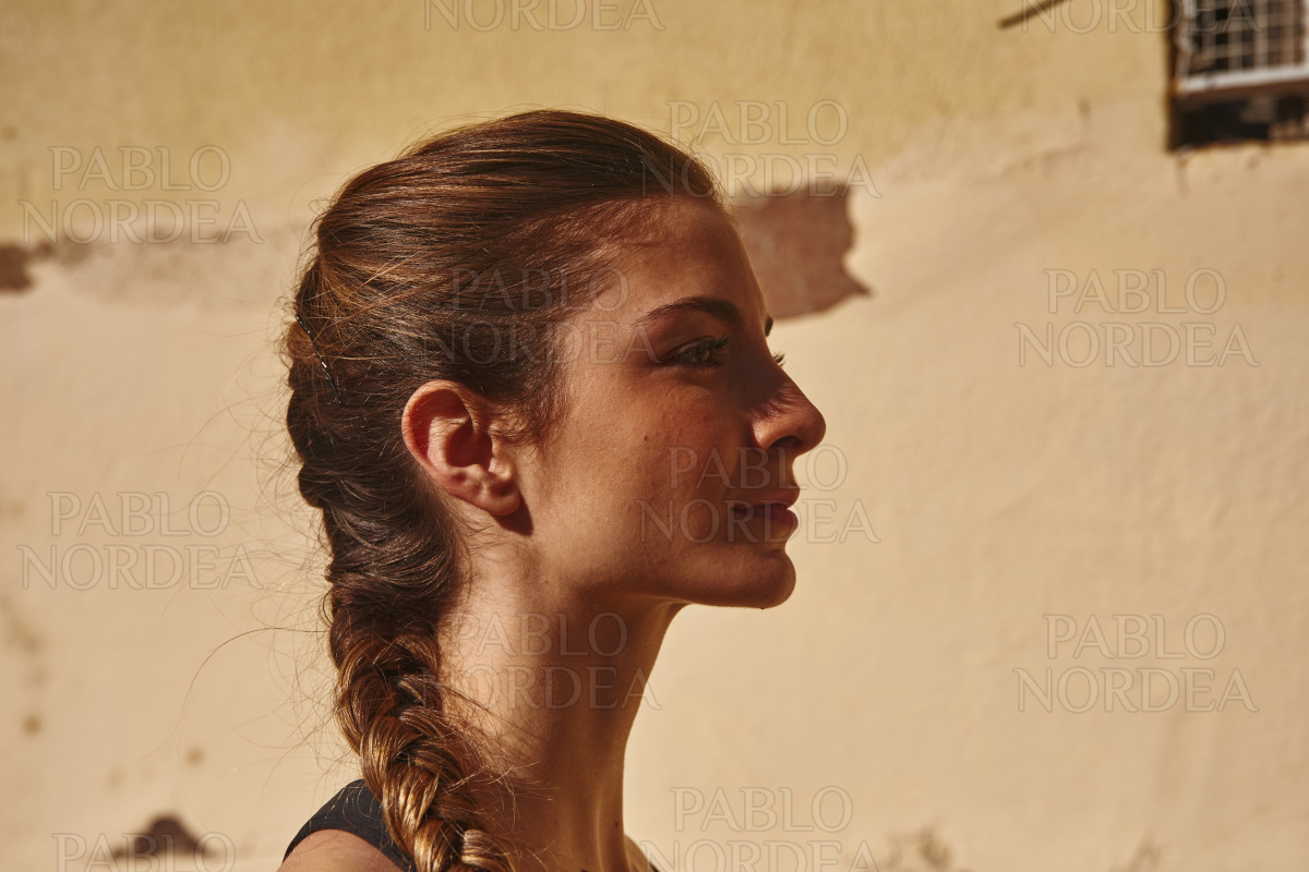 Side view of a woman looking into the distance stock photo