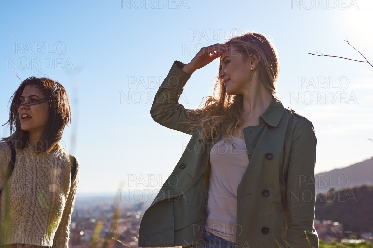 Two adult women looking at view in mountains stock photo