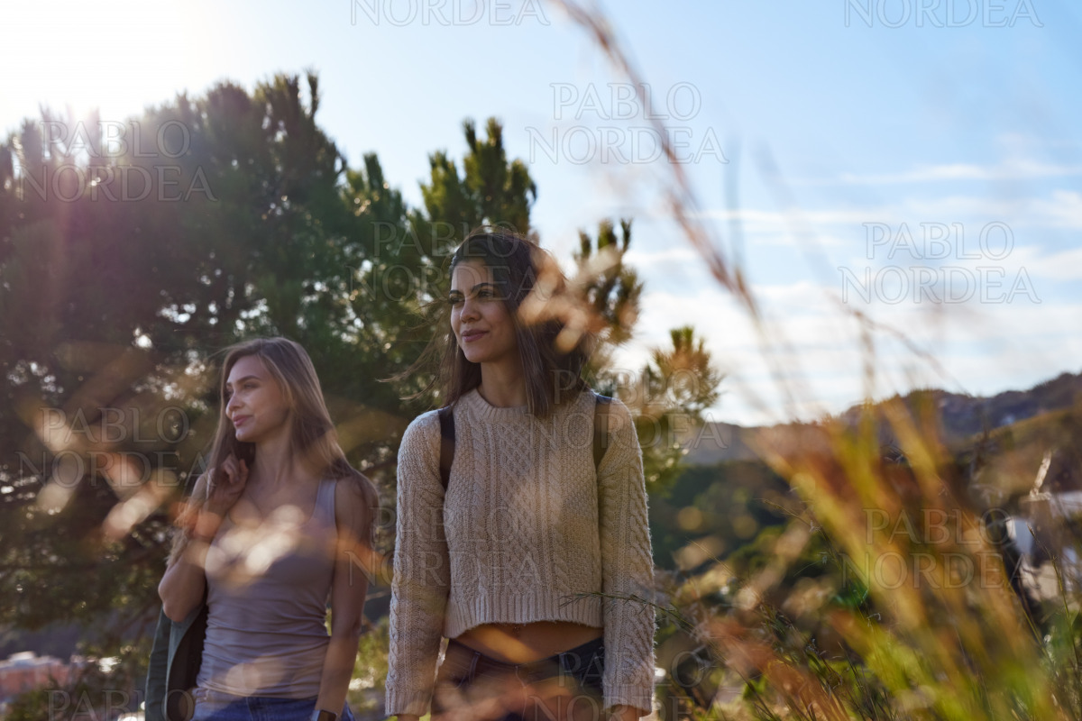 Two adult women standing on mountain stock photo
