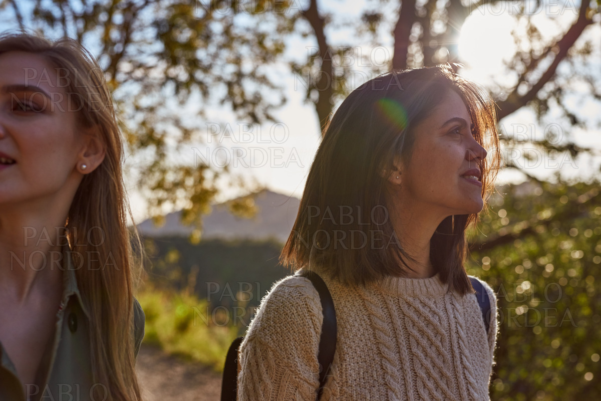 Two beautiful women in mountains on sunny day stock photo