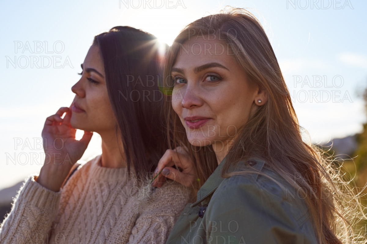 Two caucasian ladies standing outside together stock photo