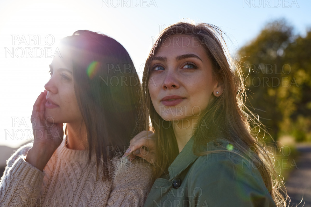 Two determined ladies standing outside together stock photo