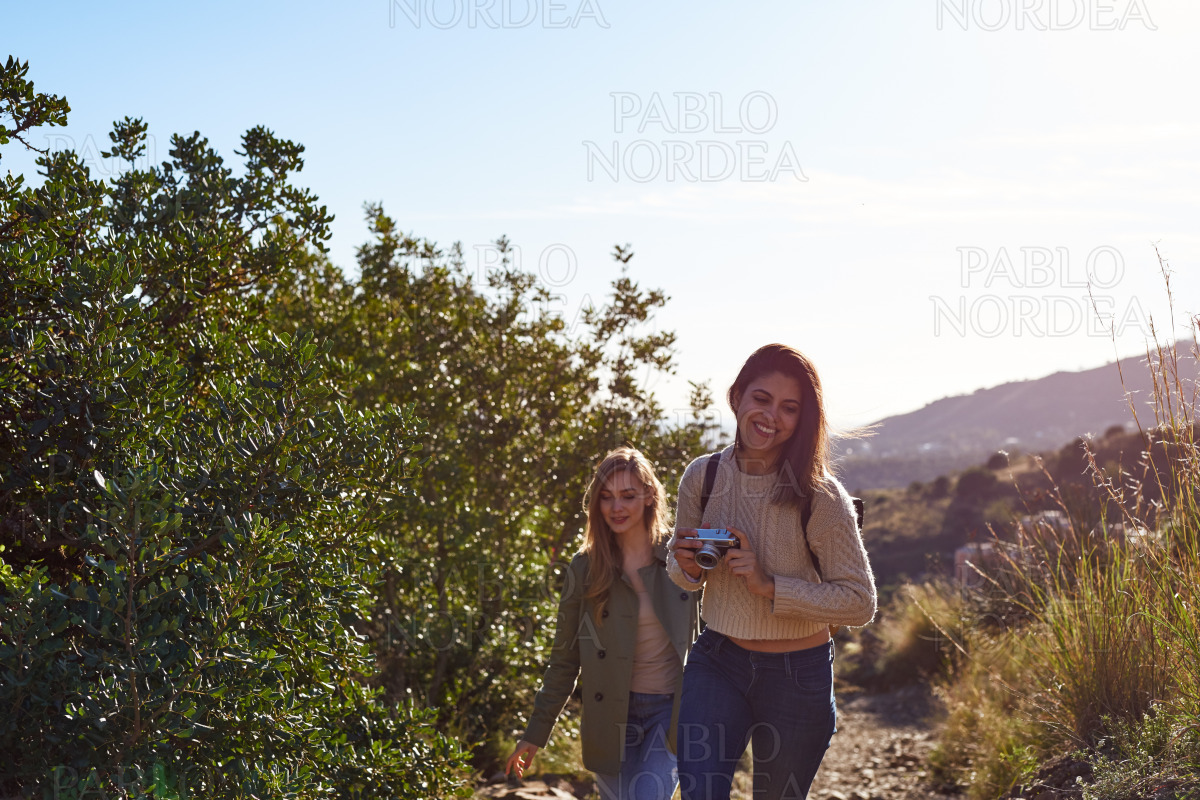 Two female friends enjoying holidays in mountains stock photo