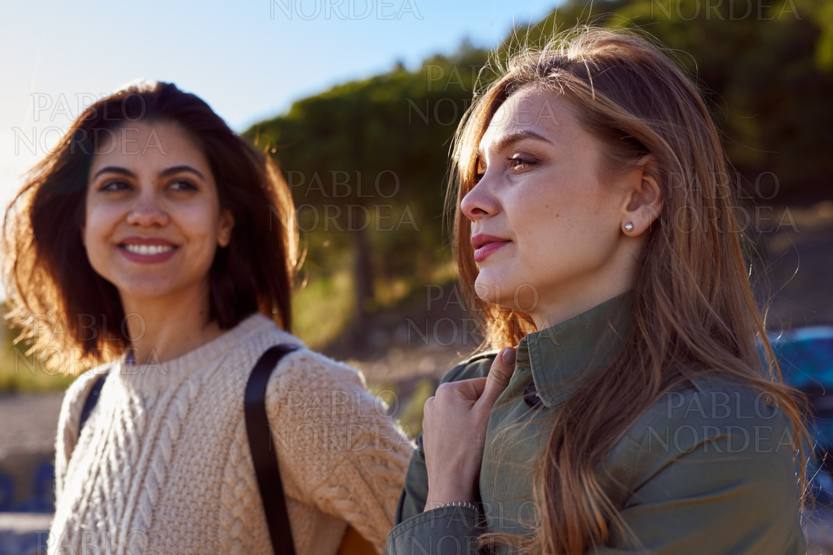 Two relaxed ladies taking a breather on a hill stock photo