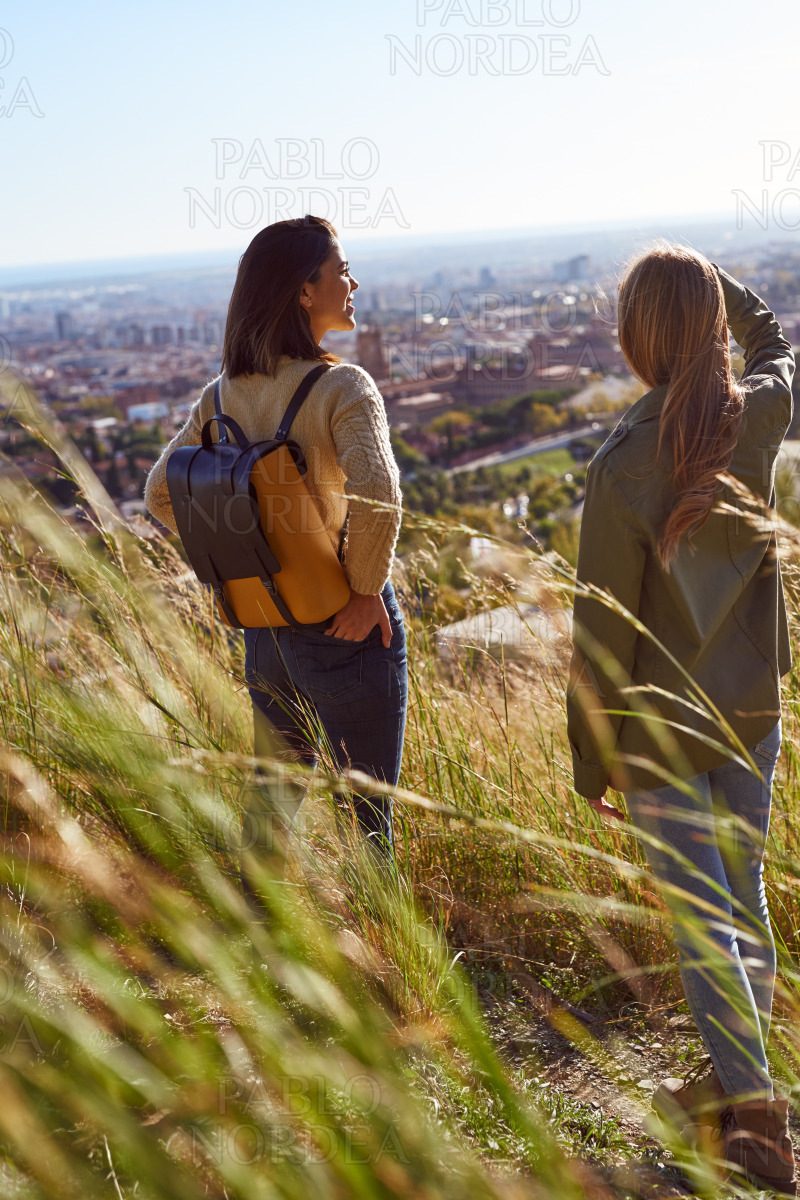 Two young women looking at the view outdoors stock photo