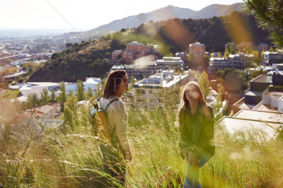 Adventurous friends standing on a hilltop outdoors