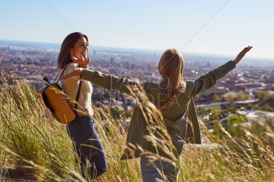 Cheerful female friends celebrating during a hike