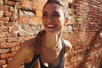 Laughing young woman looks away from the camera