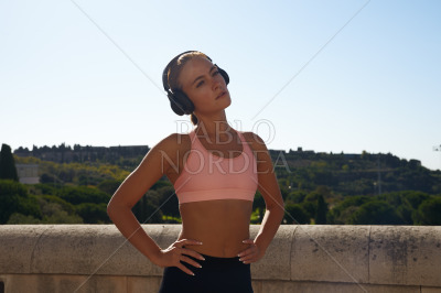 Portrait of blond female athlete in park