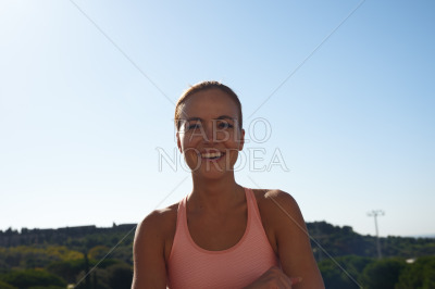 Portrait of smiling woman in pink sports bra