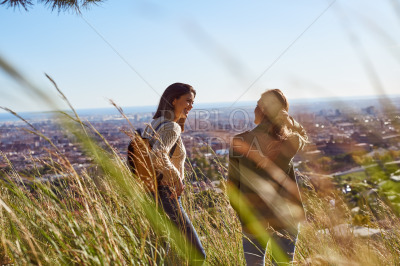 Two friends having a chat on a hilltop