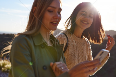 Two ladies smiling having an exciting conversation