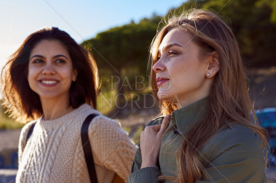 Two relaxed ladies taking a breather on a hill