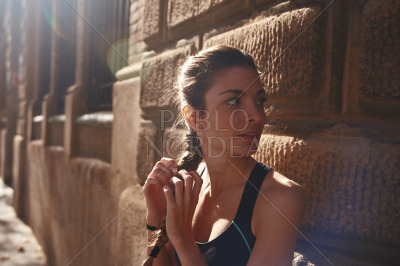 Woman is touching her long braid of hair