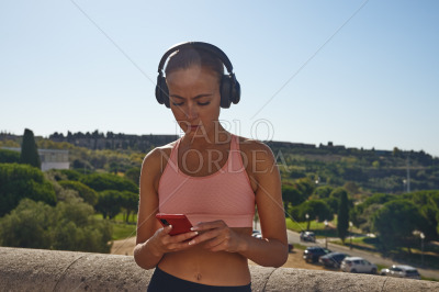 Woman listening to music and text messaging