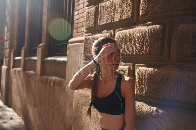 Woman shields her eyes from the sun