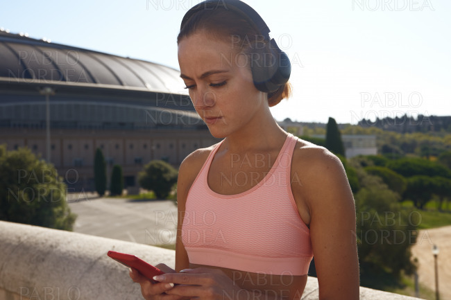 Beautiful fit woman listening to music
