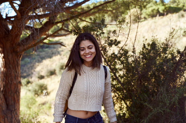 Happy young woman smiling cheerfully outdoors