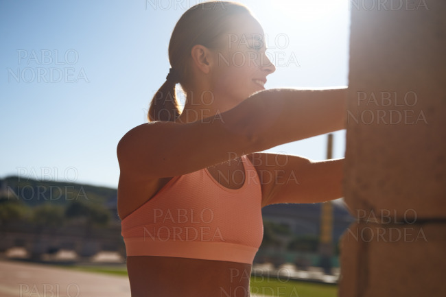 Smiling woman stretching and looking away stock photo