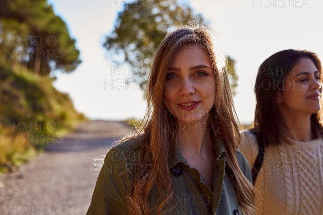 Two female friends on mountain road