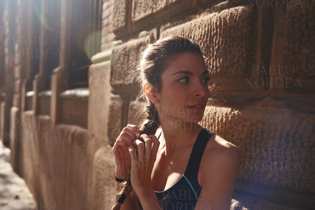 Woman is touching her long braid of hair