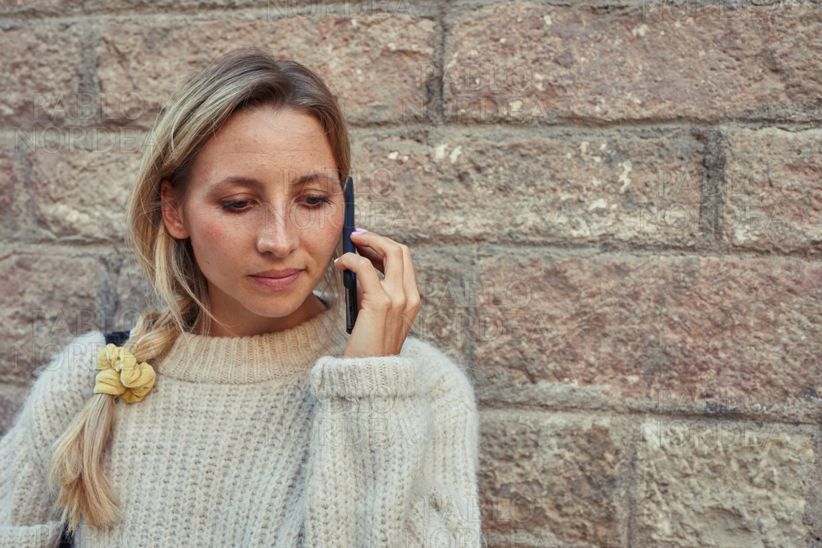 Attractive young woman making a phonecall outdoors stock photo