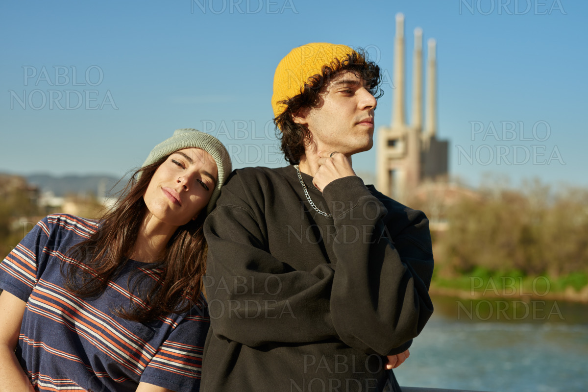 Beautiful girl leaning on guy outdoors stock photo
