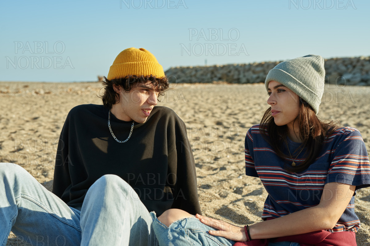 Cute young couple having a discussion outdoors stock photo