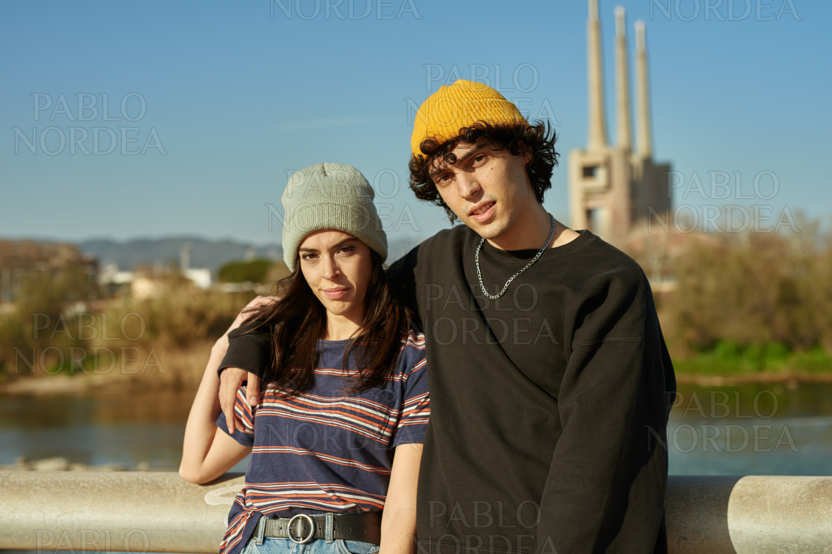 Guy with arm around his girl outdoors stock photo