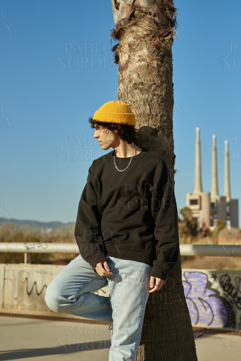 Handsome young man looking away outdoors stock photo