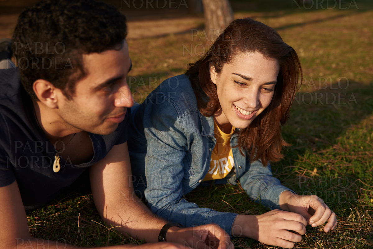 Smiling young couple relaxing in the park stock photo