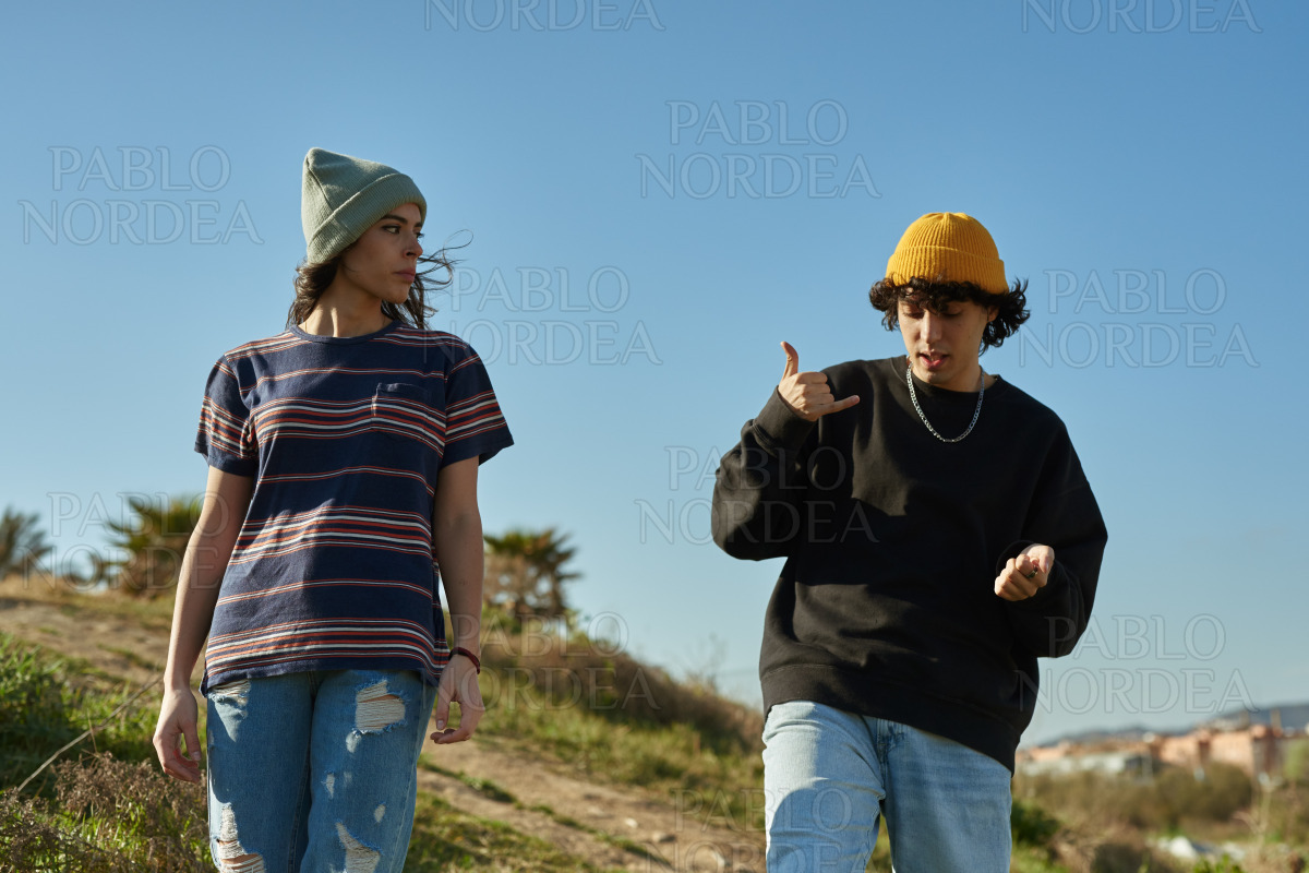 Two free young people walking down a hill stock photo