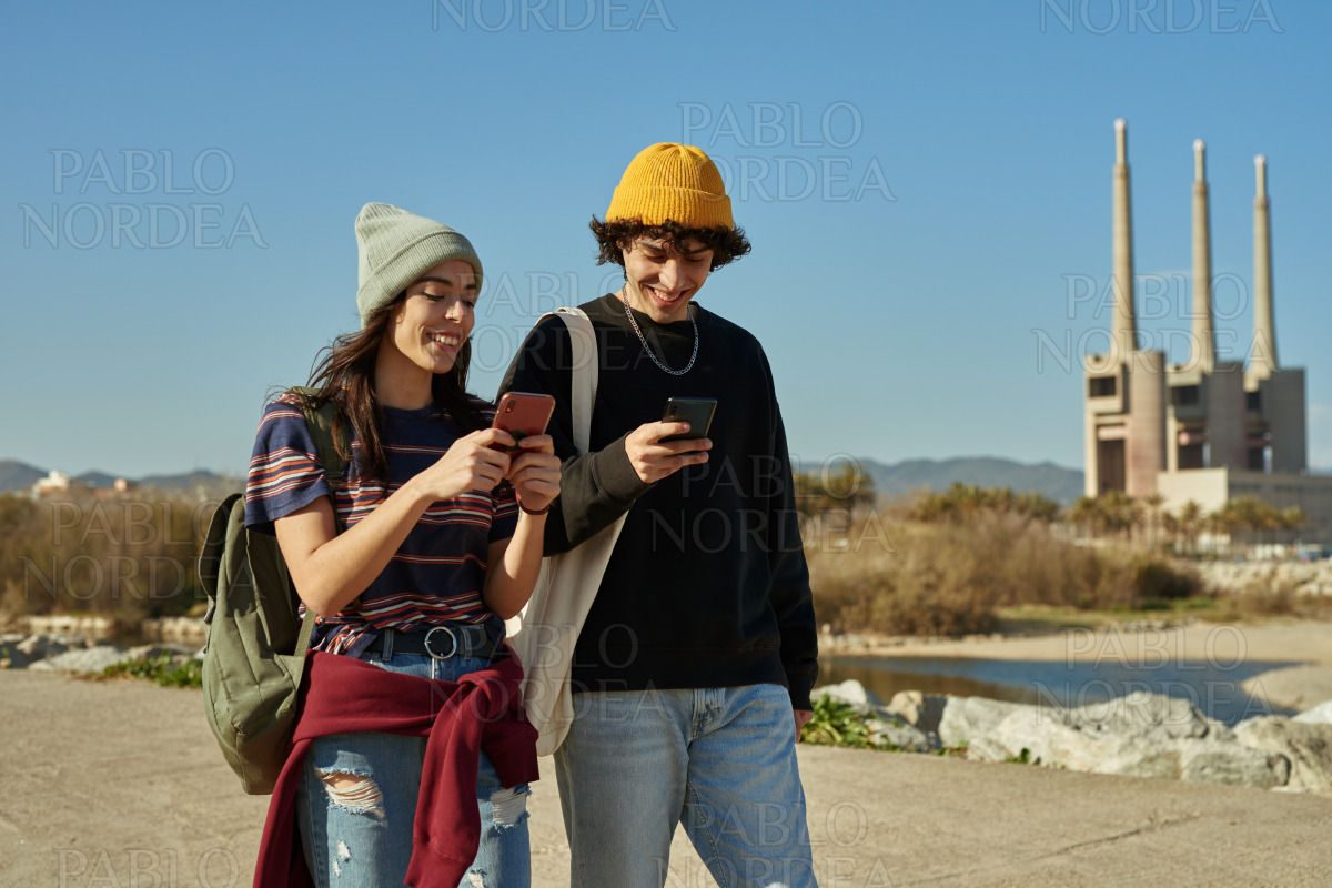 Two merry young people talking a walk stock photo