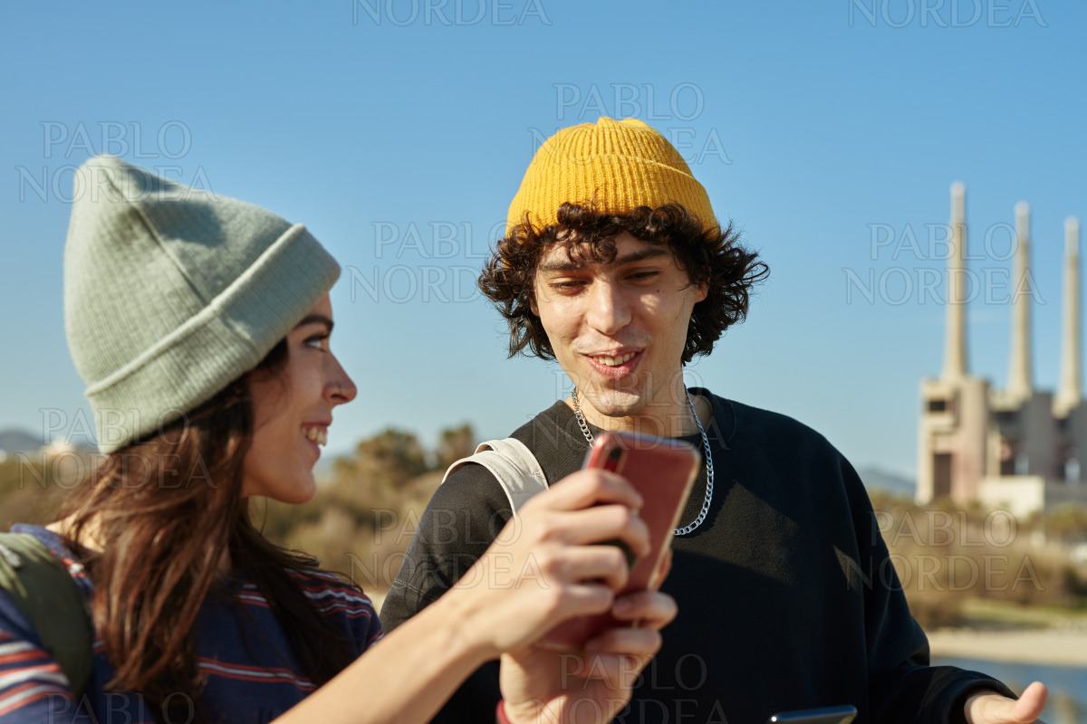 Two thrilled young people having a happy chat stock photo