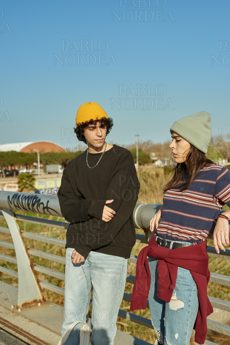 Young couple having a chat on a bridge stock photo