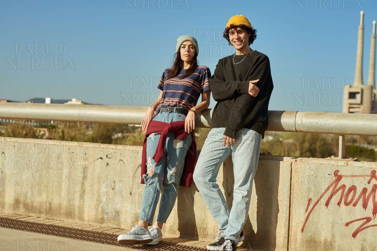 Young couple looking at you outdoors stock photo