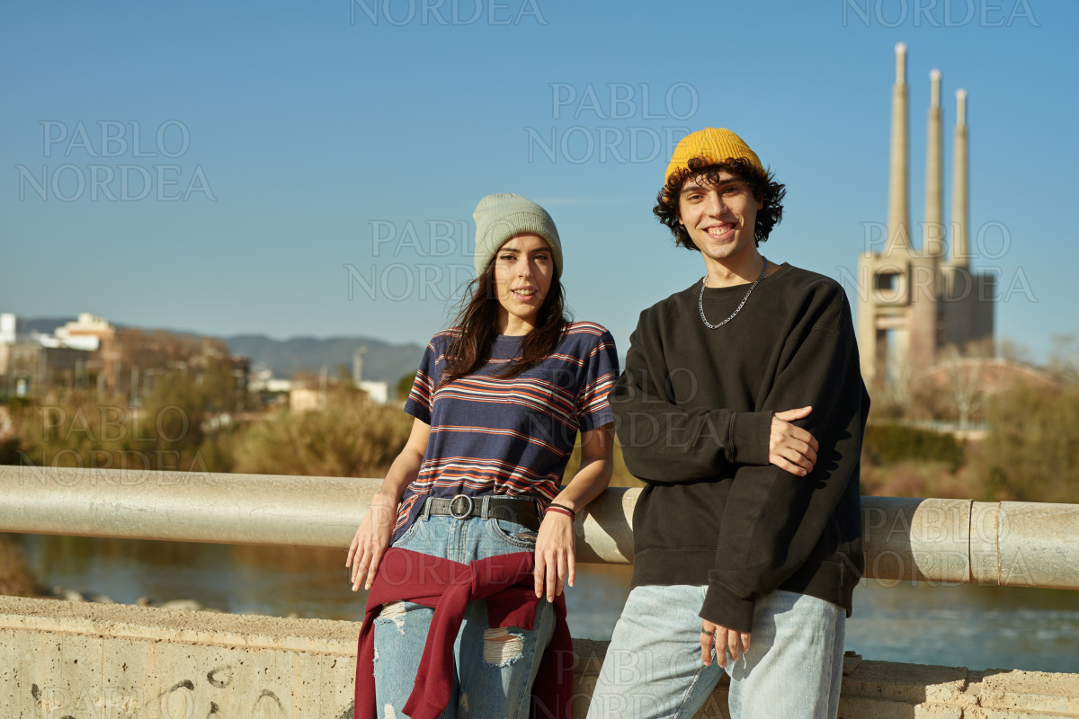 Young couple smiling at camera outdoors stock photo