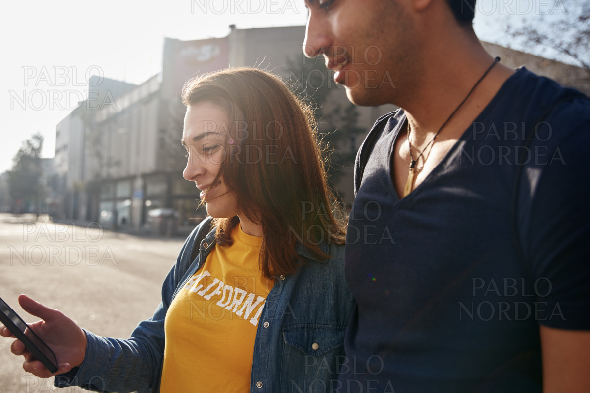 Young couple standing on a city street together stock photo