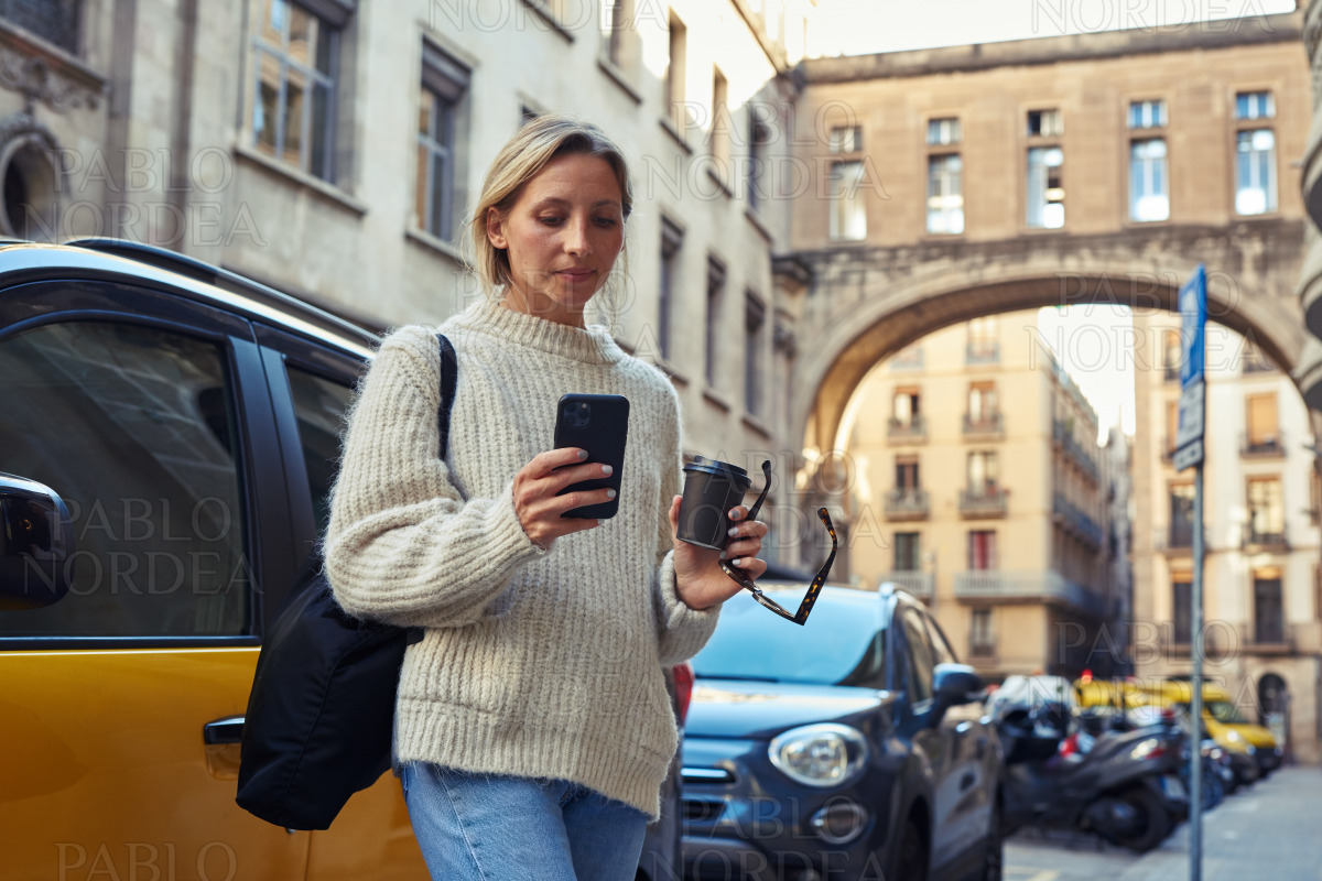 Young woman using cellphone in the city stock photo