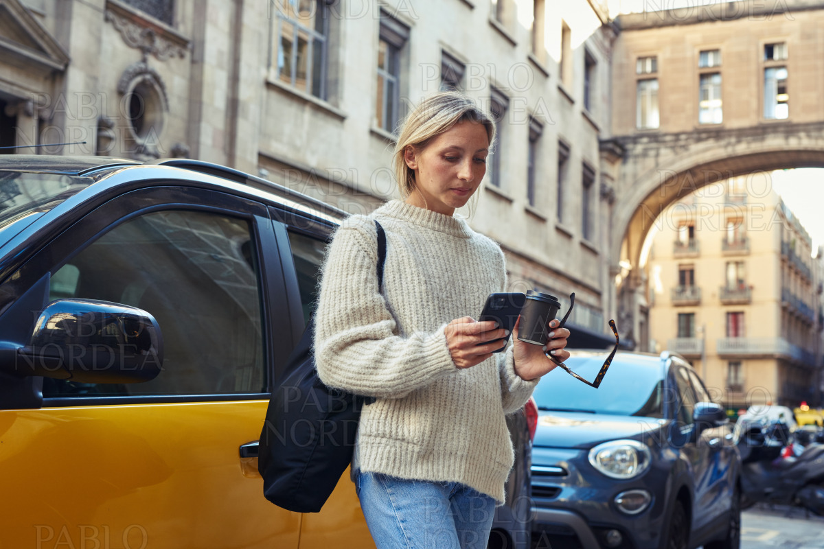 Young woman using phone in the city stock photo