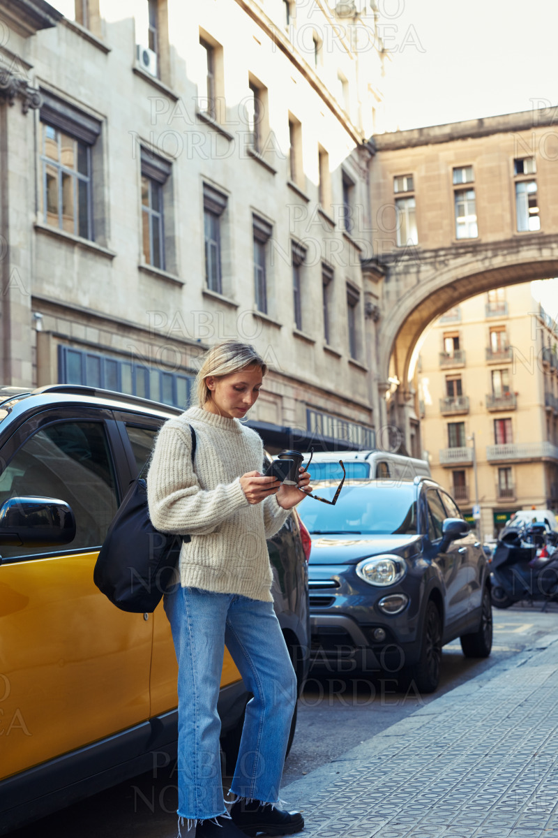 Young woman using smartphone in the city stock photo