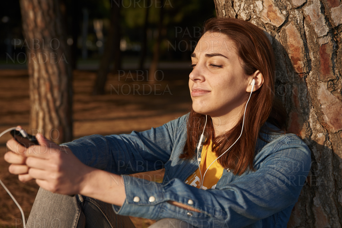 Young woman with with speakers in her ears stock photo