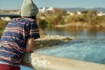 Girl looking over bridge during the day