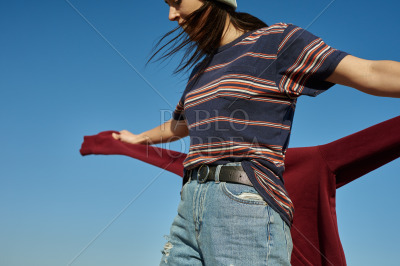 An airy young lady walking outside in the wind